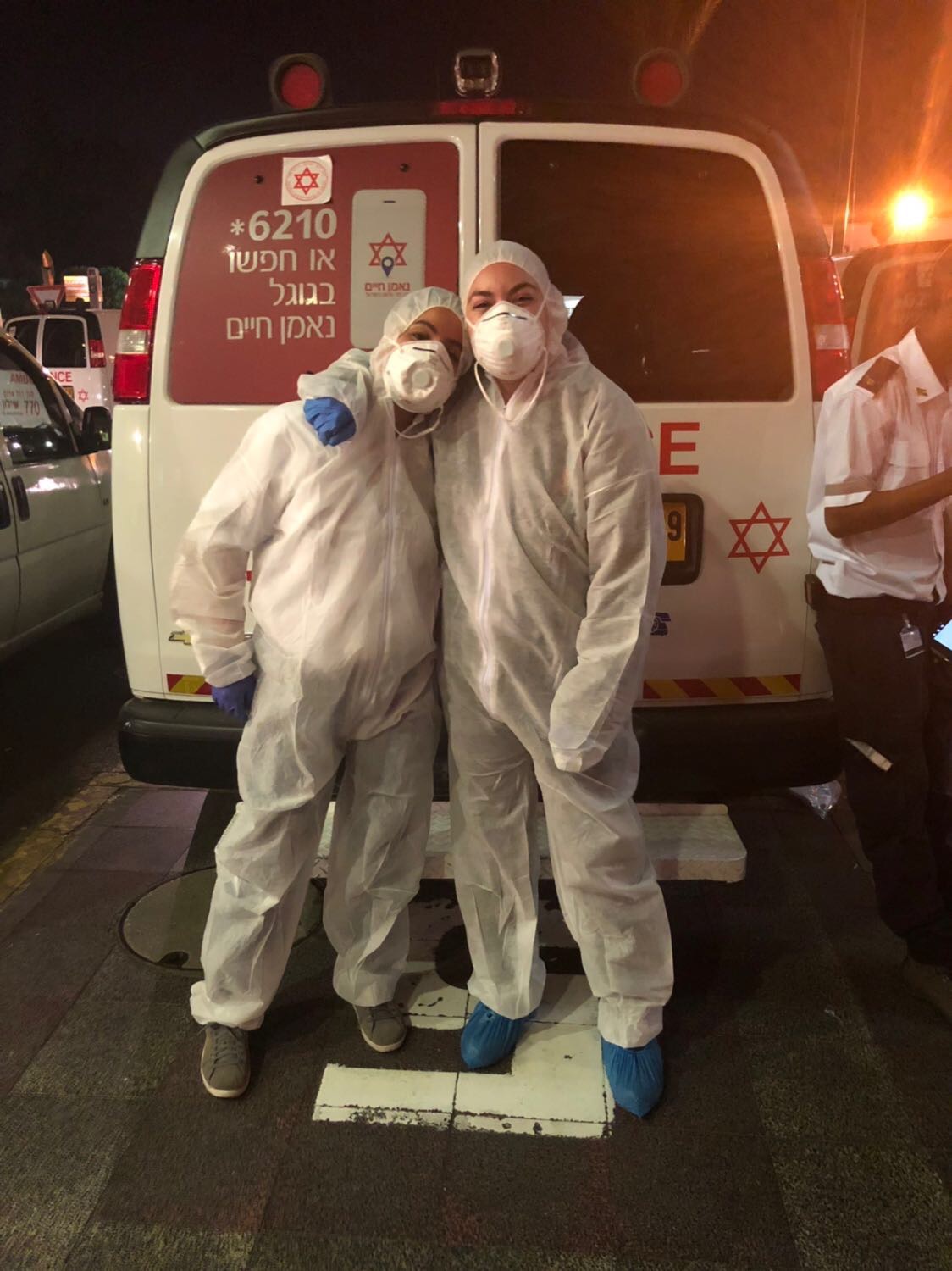 Image of Tess Seltzer Wearing biohazard protection suits after transporting a patient with an infectious disease.