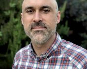 Nick Barr portrait, with foliage in background