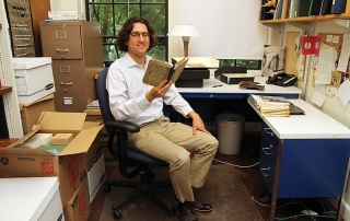 Devin in Office with Book