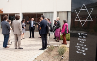 Harley and Lela Franco show the Rhodes Holocaust memorial and courtyard at Congregation Ezra Bessaroth to the scholars who participated in the Sephardic Jewry and the Holocaust symposium.