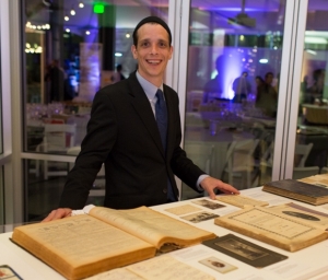 Ty Alhadeff with the exhibit of Seattle Sephardic Treasures at the Jewish Studies 40th Anniversary Gala. Photo by Meryl Schenker.