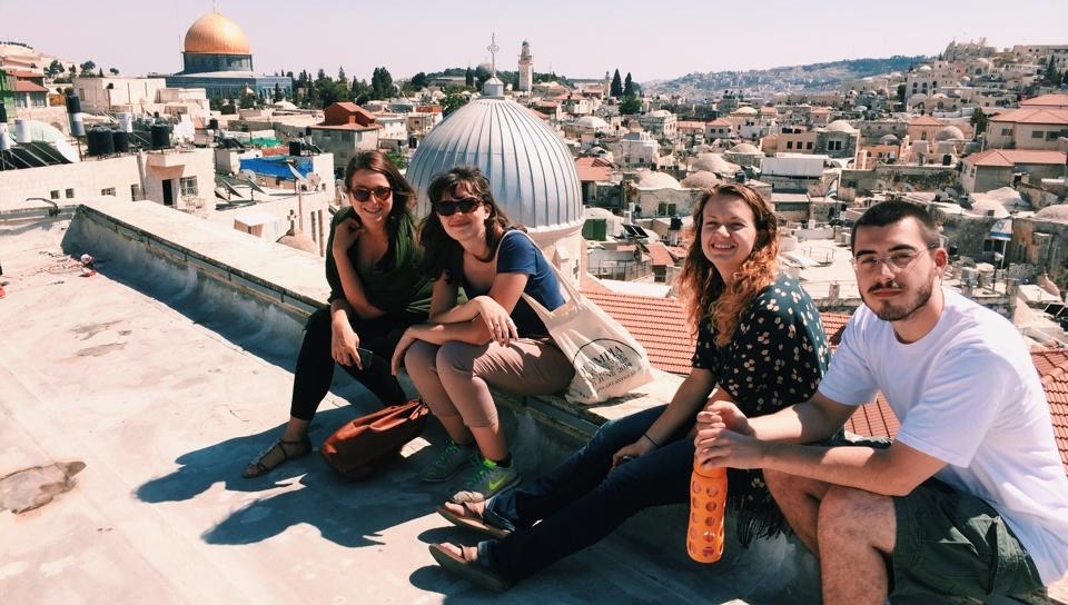 Jenna Mark, second from right, sits on top of the Austrian Hospice in the Old City of Jerusalem.
