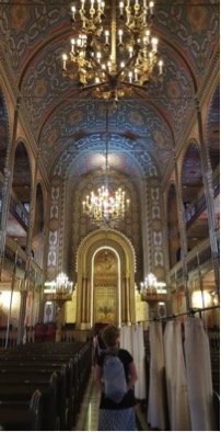 This synagogue in Tblisi, Georgia is lined with wooden benches, and an interlocked pattern of Stars of David can be seen on the walls. The architecture is an identical match of colors, style and materials to that of the churches in the area. 