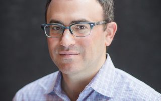 Daniel Schwartz in a button-down shirt and glasses