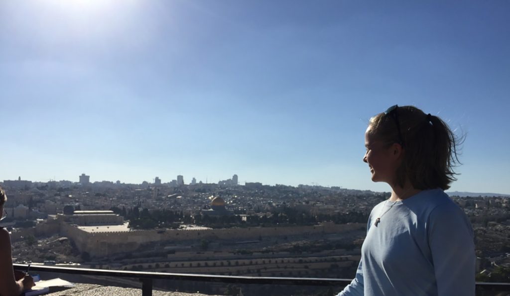 Student Marissa Gaston looks out over Jerusalem under a blue sky