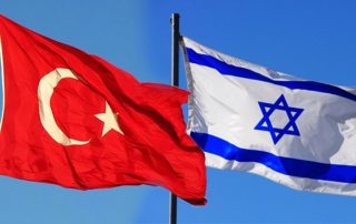 The red Turkish flag showing crescent moon and star flies with the white Israeli flag with blue stripes and Star of David next to it