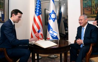 Donald Trump's son-in-law, Jared Kushner, sits across from Israeli Prime Minister Benjamin Netanyahu in an official office where the U.S. and Israel's flags are displayed