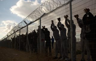 Israeli prisoners protesting at a barbed wire fence