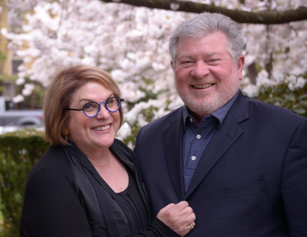 Joel and Maureen Benoliel with cherry blossoms in the background.