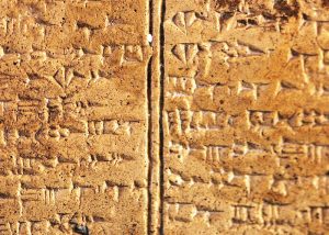 Stone tablet engraved with cuneiform (wedge) Ugaritic writing