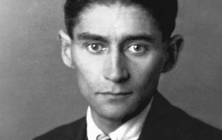Black-and-white studio photo of Franz Kafka in suit and tie