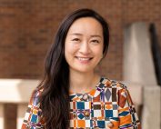 wide portrait of Kelsey "Ke" Guo smiling in bright geometric-patterned shirt