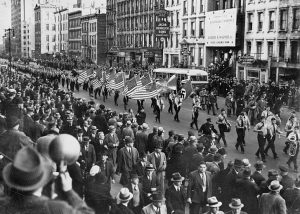 1937 German American Bund Parade, marchers are carrying American flags and Nazi iconography
