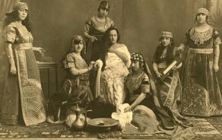 Historic black-and-white photograph showing women in traditional Ottoman attire, with musical instruments
