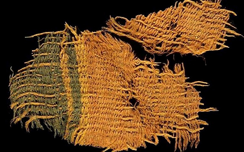 Fragment of colorful ancient cloth show careful crossweaving