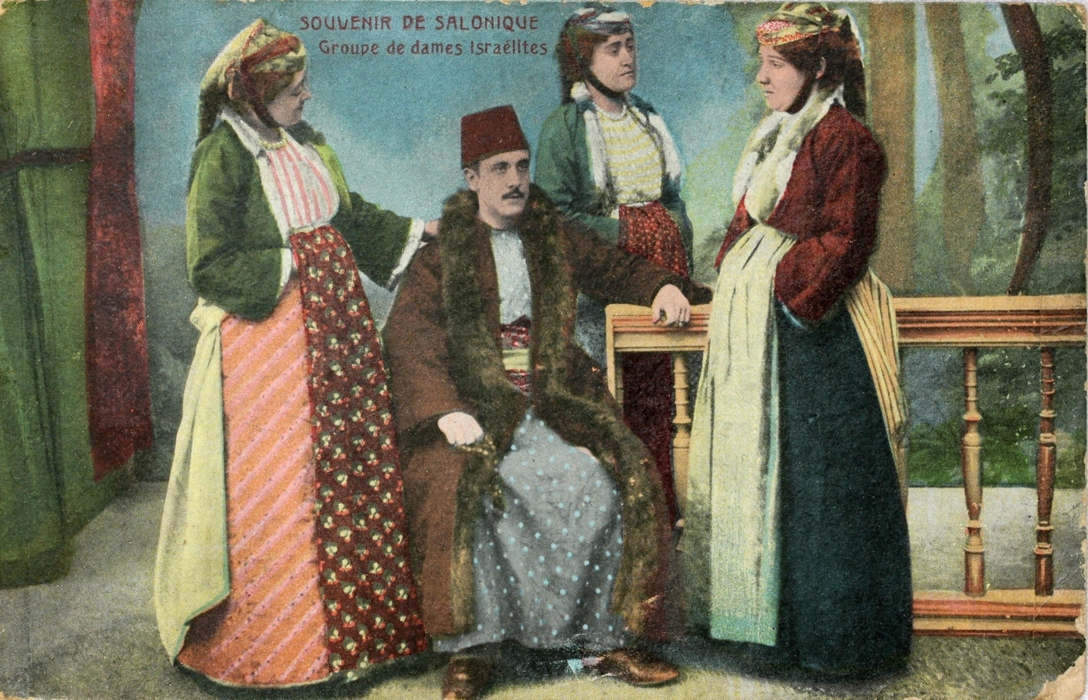 a postcard featuring four Greek Sephardic Jews seated and standing together