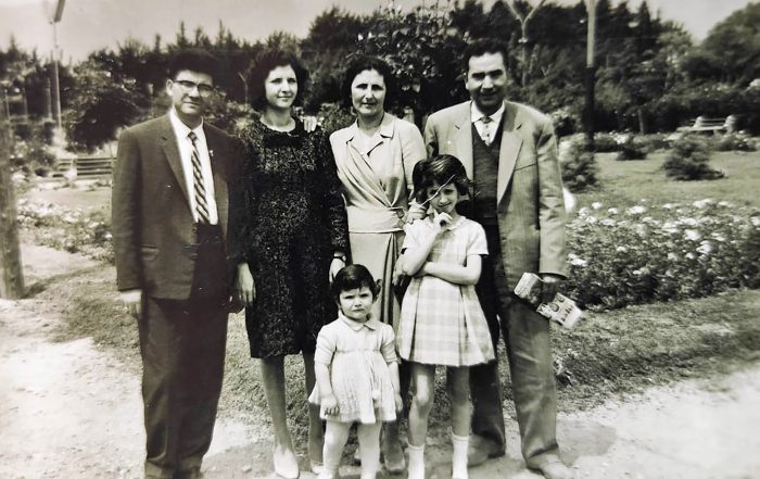 Black and white photo of family in formalwear outdoors