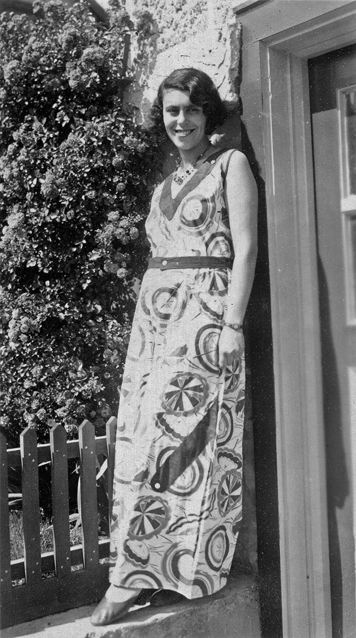 Black-and-white photo of stylish woman with short bobbed hair in elegant summer dress