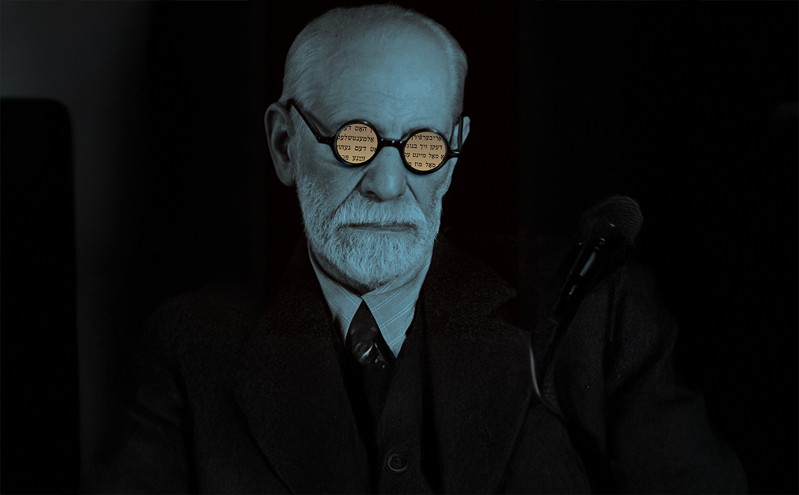 Illustration of Freud wearing glasses with Hebrew in the reflection