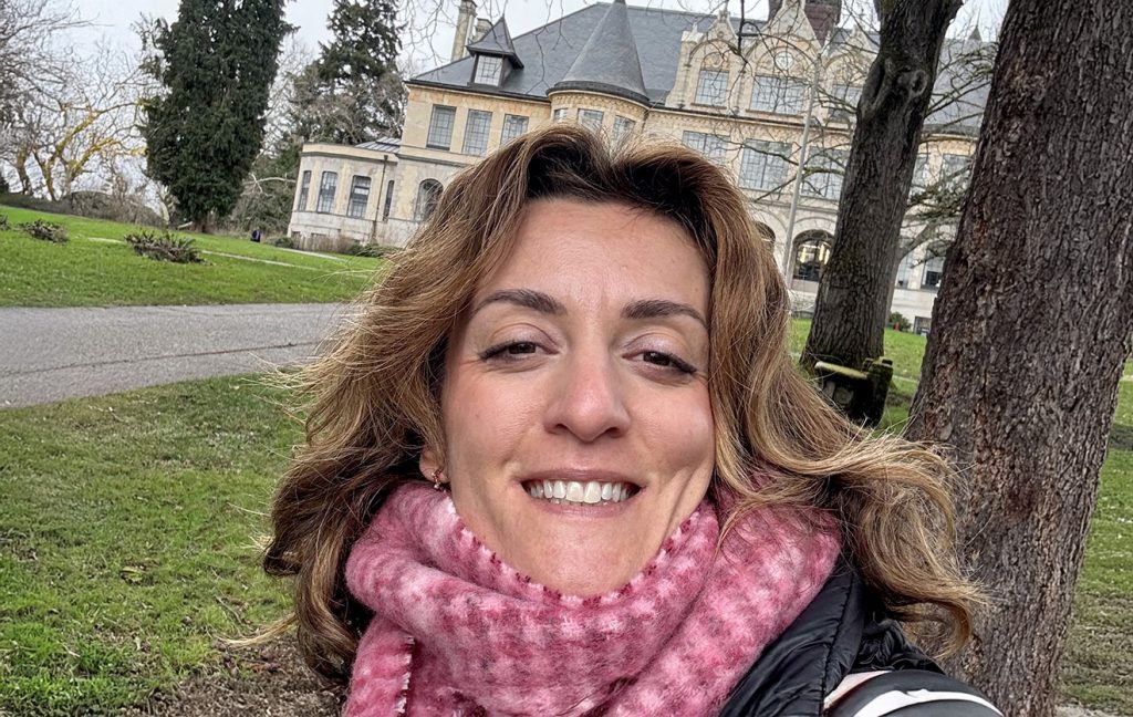 Maria Papavasilopoulou smiling on the University of Washington campus, in winter