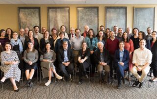 A large group photo of past and present Stroum Center faculty, graduate students, and staff