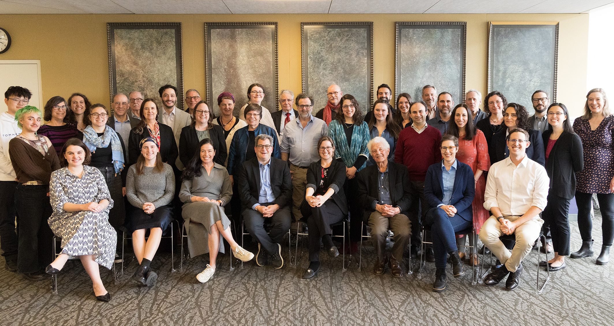 A large group photo of past and present Stroum Center faculty, graduate students, and staff