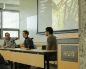 Three panelists seated at long table at the UW