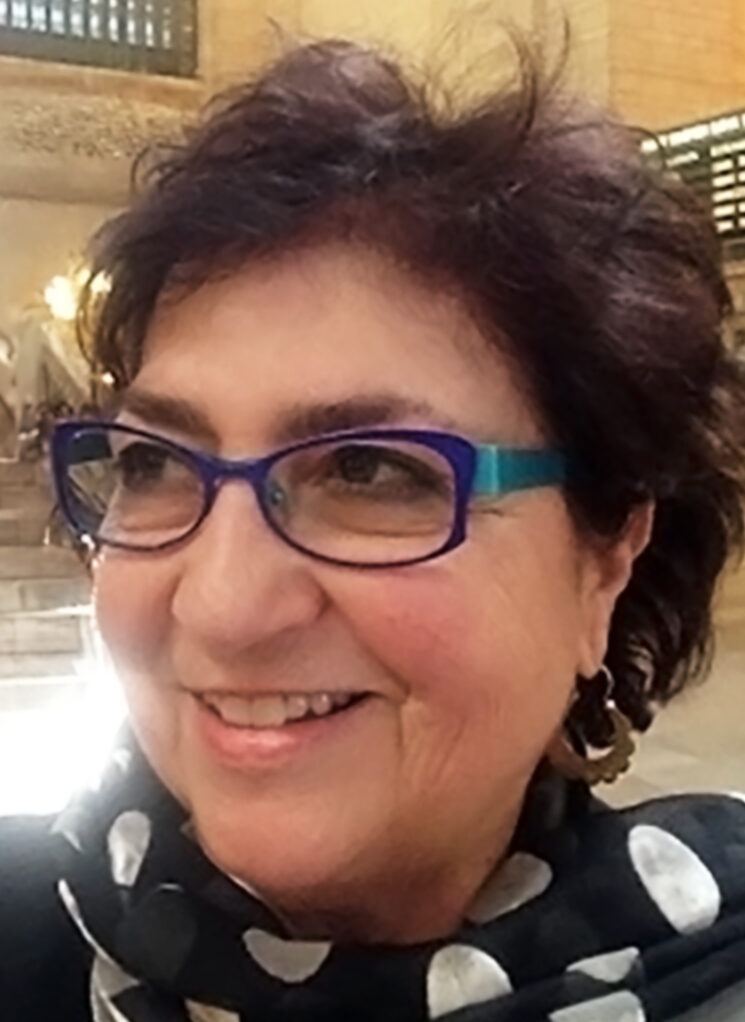 Rina Benmayor smiling, in sunny open space