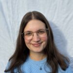 Woman in blue sweater and glasses