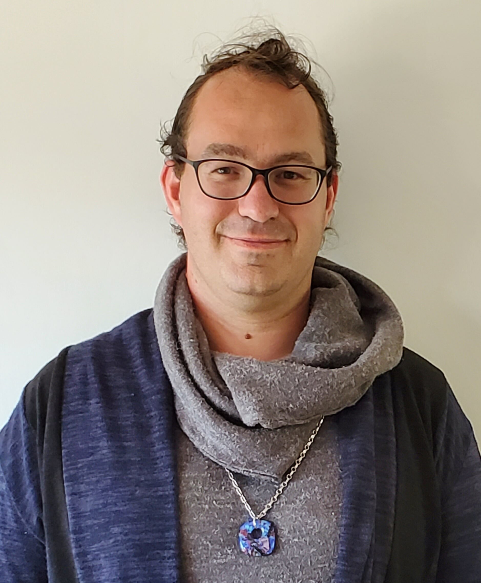 Man wearing scarf and glasses