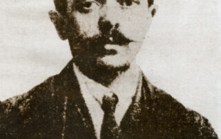 An old black and white portrait of a man in a suit.