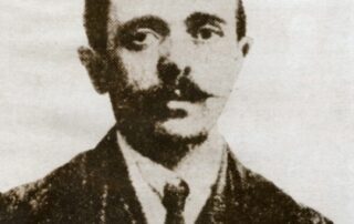 An old black and white portrait of a man in a suit.