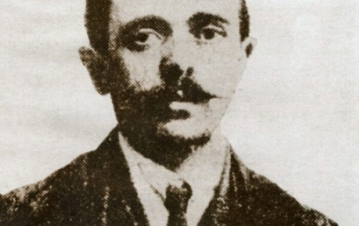 An old black and white portrait of a man in a suit.